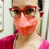 Contributor with red glasses, peach mask and pink hospital gown
