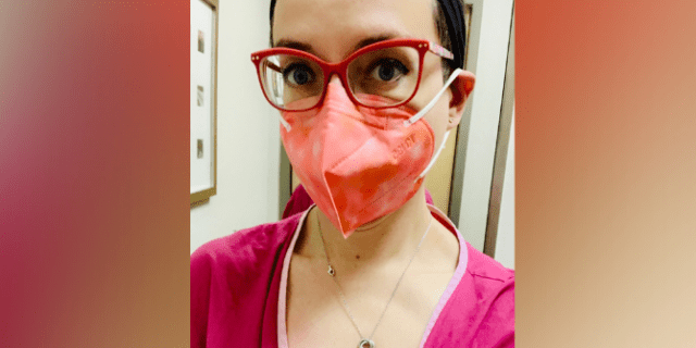 Contributor with red glasses, peach mask and pink hospital gown