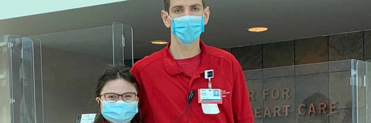 The Importance of Belonging at Work for People With Disabilities Rachel wearing a uniform on her first day at her new job, standing next to a colleague with arms around each other