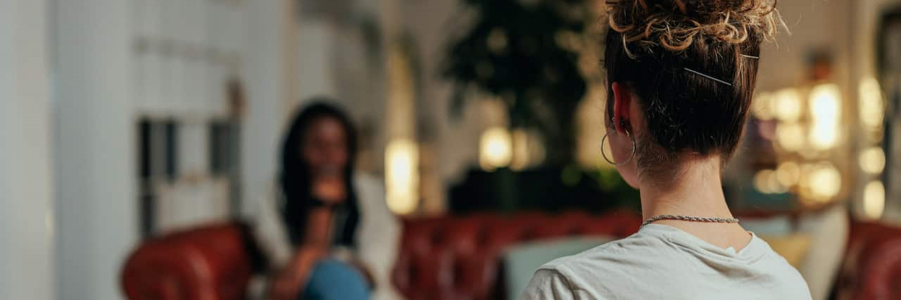 The Importance of Your Therapist Balancing Authenticity While Maintaining Boundaries View from behind of female therapist in session with patient