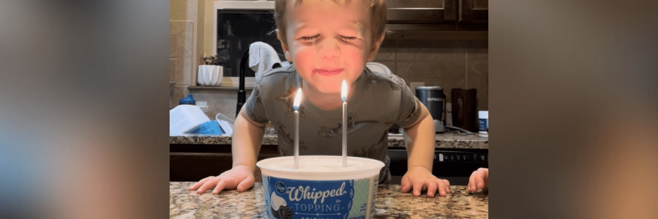 How a Rare Metabolic Disorder Makes Our Family’s Pantry and Grocery Bill Look Different Image of contributor's son blowing out candles on a "cake" in a whipped cream tub
