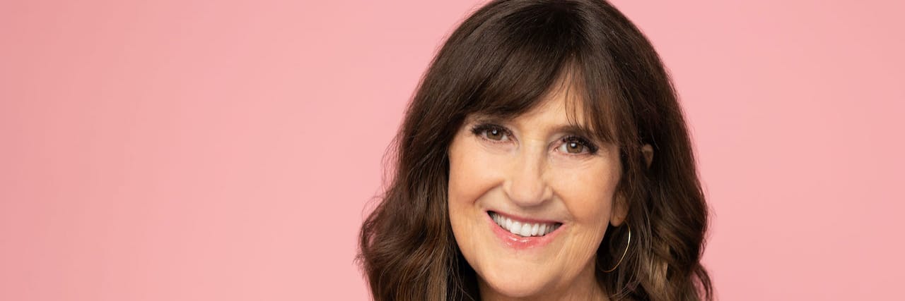 A Friend's Cancer, My Own Kidney Disease Diagnosis and Learning About Quality of Life Image of contributor smiling at the camera in front of a pink background