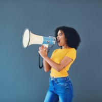 Woman of color speaking into a megaphone