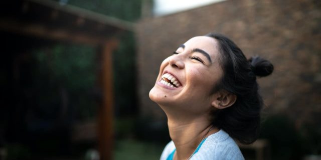 Woman smiling and looking up at the sky