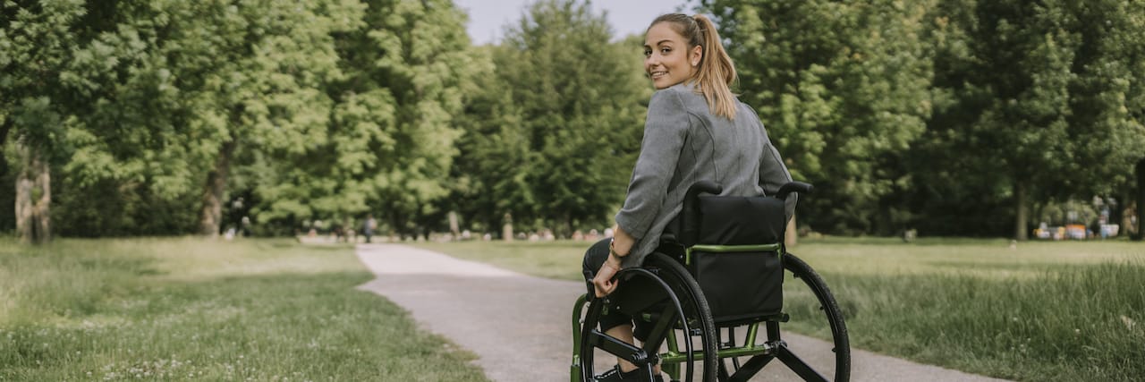 When I Realized It's OK to Use a Wheelchair Part-Time Woman using wheelchair outside on path