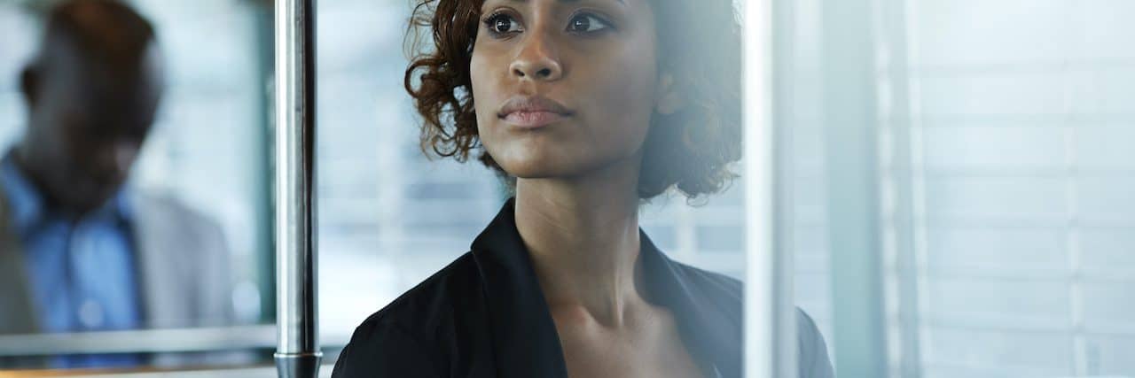Living With Limitations and Borderline Personality Disorder Woman of color in business attire sitting on public transportation