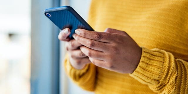 25 Life-Changing Apps for People With Disabilities Woman of color holding phone in her hands