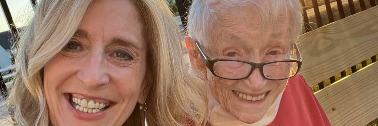 How Love Can Break Through the Darkness of Dementia Contributor sitting outside with her mother, with the sunset behind them