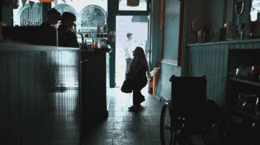 Ella Glendining in "Is There Anybody Out There" in a coffee shop next to her wheelchair