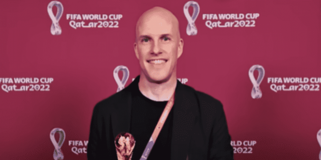 Grant Wahl in front of a red World Cup background