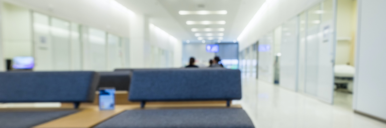 Blurred photo of nearly empty hospital waiting room