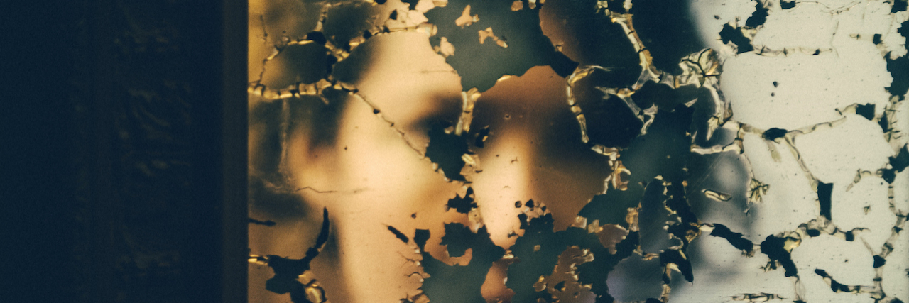 I Want to Help You Understand What It's Like to Live With Chronic Pain Woman's reflection broken up by damaged mirror