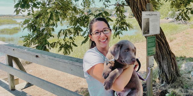 Accepting the Truth as a Neurodivergent Zebra Photo of contributor standing outside, smiling and holding a puppy