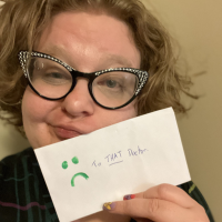 Image of contributor wearing glasses and holding an envelope with the words "To THAT doctor" and a frowny face