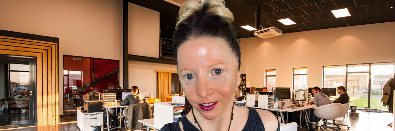 How to Navigate a Job Search When You Have a Disability Contributor sitting with office behind her