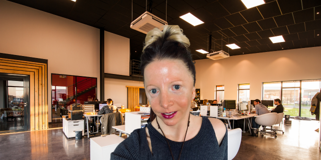 How to Navigate a Job Search When You Have a Disability Contributor sitting with office behind her