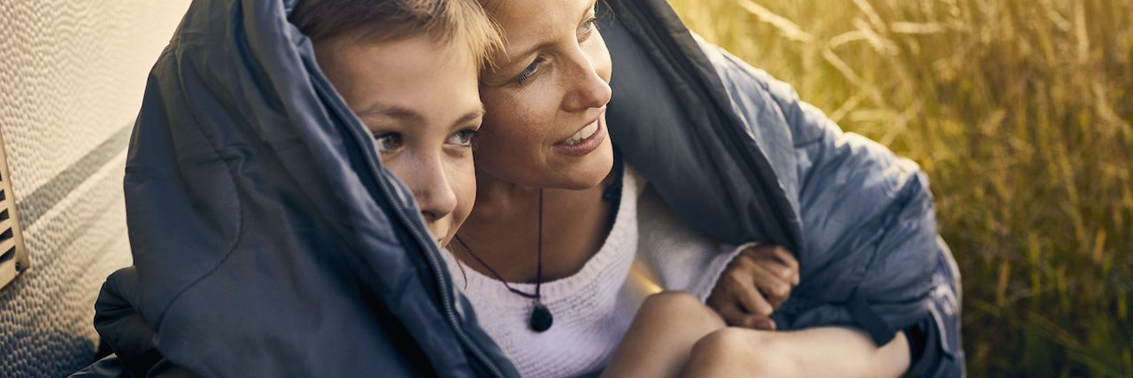 When Your Child Has Disruptive Mood Dysregulation Disorder Mother and son huddled under a blanket outside