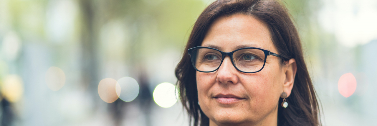 The Myth of Medical Marijuana Access Woman walking outside with background blurred behind her