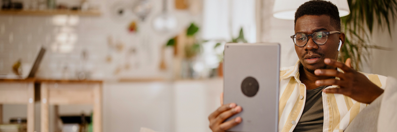 My Top 3 Favorite Mental Health Apps  A young Black man at home holding a tablet and speaking