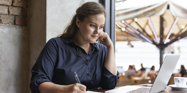 Even Professional Health Advocates Need Help Sometimes Woman working at laptop and taking notes