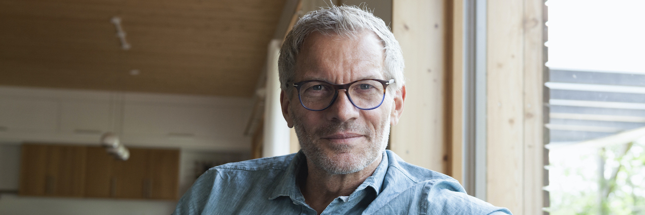 How an Autism Diagnosis at 65 Shook My Sense of Self Portrait of confident man sitting on couch