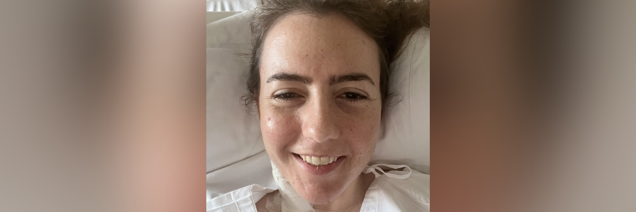 What It's Like to Face Each Day With Rare Disease  Contributor with head on pillow and in a hospital gown, with medical tape and bandages on her neck
