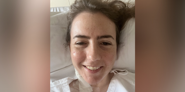 What It's Like to Face Each Day With Rare Disease  Contributor with head on pillow and in a hospital gown, with medical tape and bandages on her neck