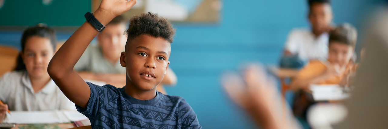 Things Kids With ADHD and Their Moms Wish Teachers Knew Black elementary student raising his hand in classroom