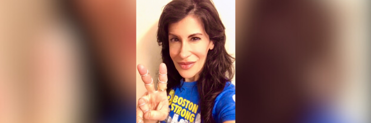 10 Lessons I Learned in 10 Years Since Surviving the Boston Marathon Bombing Contributor wearing a blue Boston strong t-shirt and giving the peace sign