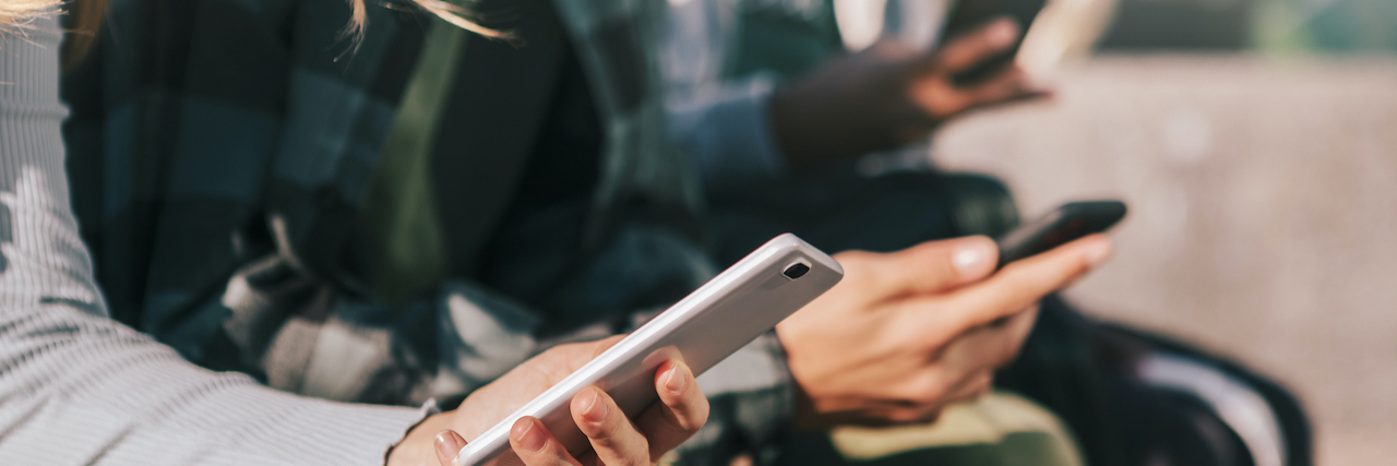 What the Advisory on Teen Social Media Use and Mental Health Missed Close up of teenagers holding phones in their hands