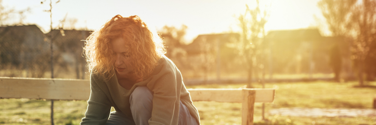 When You Sacrifice Your Physical Health for Your Mental Health Woman planting flowers in backyard garden