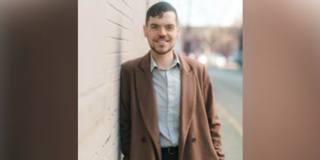 Disability Advocate Taking the South by Storm with New Nonprofit Dominic Kelly standing next to a brick wall