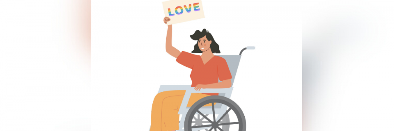 Woman in wheelchair holding a rainbow sign that says "Love"