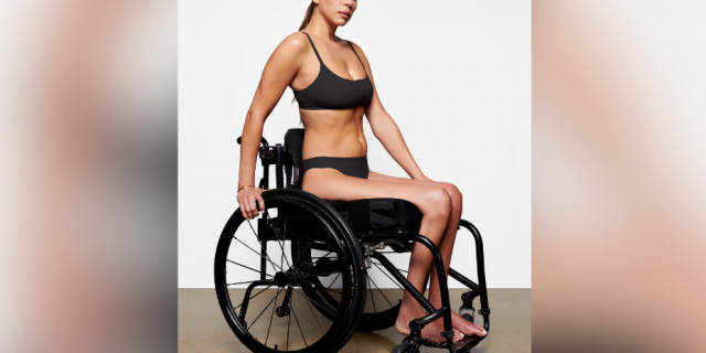 Model wearing adaptive bra and underwear sitting in a wheelchair