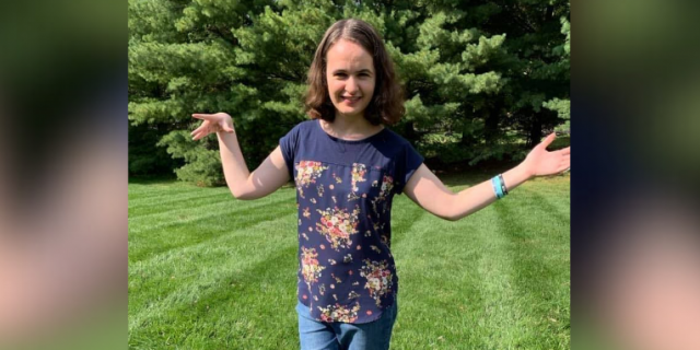 What It's Like Living 'in Between' With Disability  Contributor standing outside with her arms held out