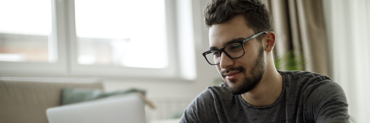 Am I Doomed to Repeat the Mistakes of My Father? Breaking Intergenerational Mental Health Cycles Man with glasses and beard on laptop