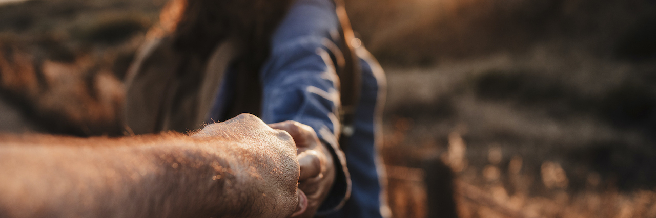 'Am I a Good Husband or Bad Caregiver?' When You Become Caregiver for Your Spouse. Man's hand holding onto woman's as she walks in front at sunset