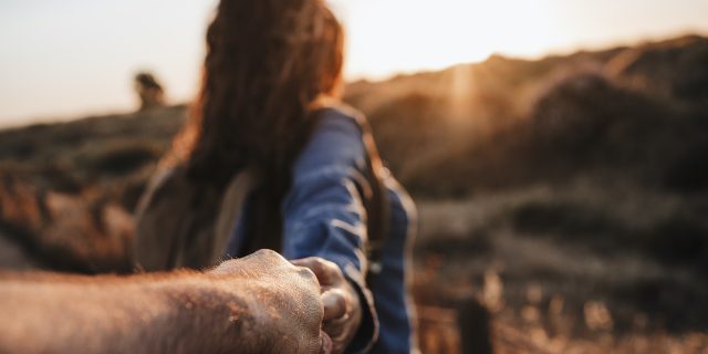 'Am I a Good Husband or Bad Caregiver?' When You Become Caregiver for Your Spouse. Man's hand holding onto woman's as she walks in front at sunset