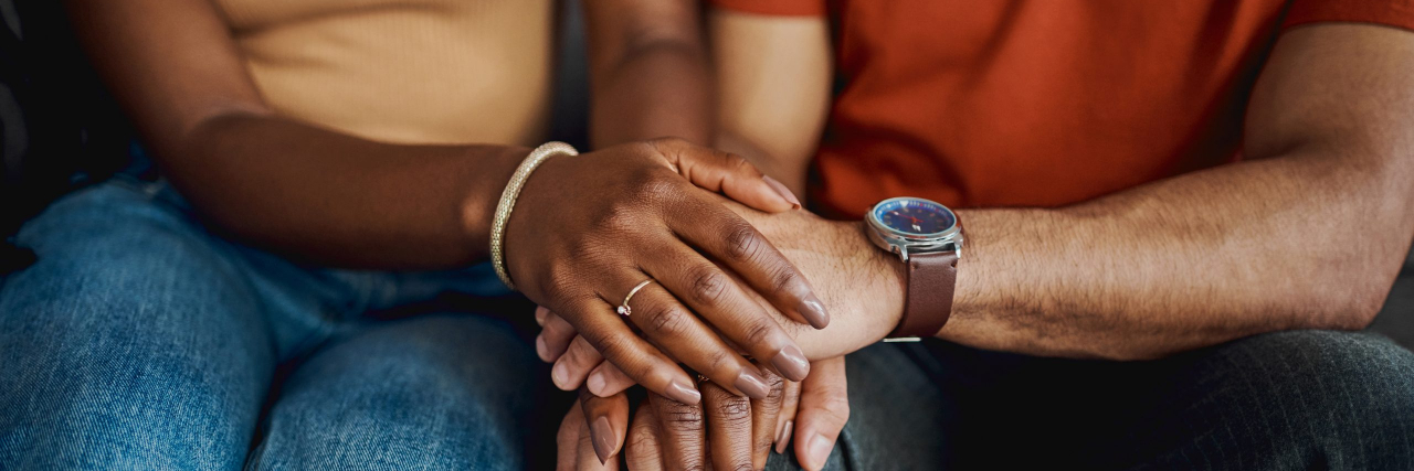 29 Secrets of Being a Caregiver Cropped shot of an unrecognisable couple sitting together on the sofa at home and holding hands