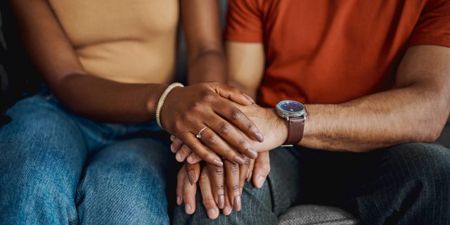 How Parkinson’s Affects Perception—and What Patients and Caregivers Can Do About It Cropped shot of an unrecognisable couple sitting together on the sofa at home and holding hands