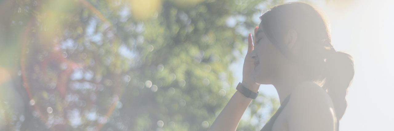 12 Strategies to Stay Safe in a Boiling World Woman holding her head outside in haze