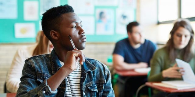 Unpacking How College Policies Impact Disabled Students Shot of a young man looking thoughtful at his desk in a classroom at university