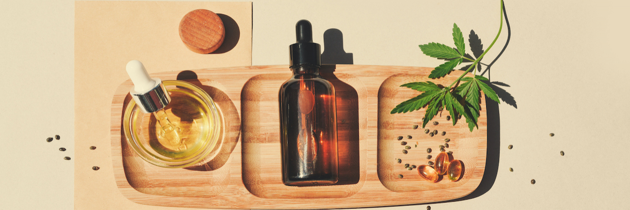 Setting the Record Straight: 19 Myths and Misconceptions About CBD CBD oil, cannabis seeds and leaves on a wooden tray