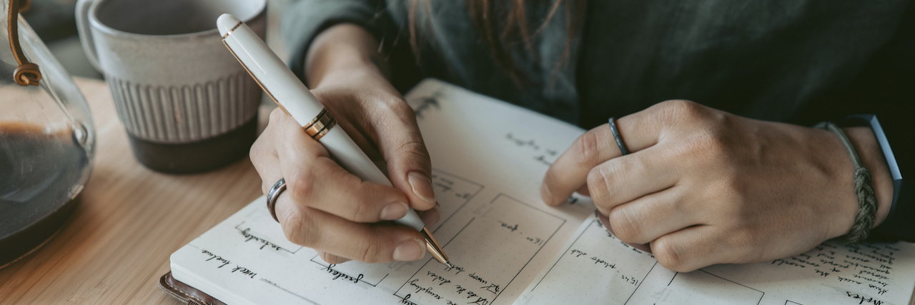 This Is It: The Planner That Will Change My Life Woman writing in planner