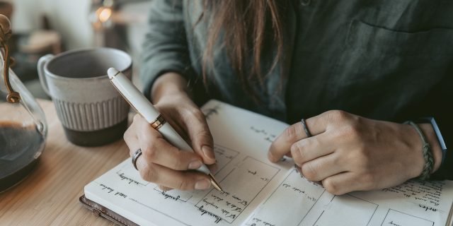 Woman writing in planner