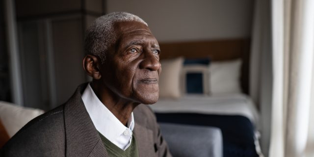 Contemplative senior Black man at home