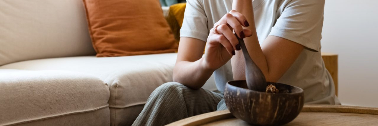 When Eating Isn't Easy: Navigating Life With Gastroparesis Young multiracial woman eating breakfast feeling very bored and unmotivated. Lack of appetite. Copy space. Lifestyle concept.