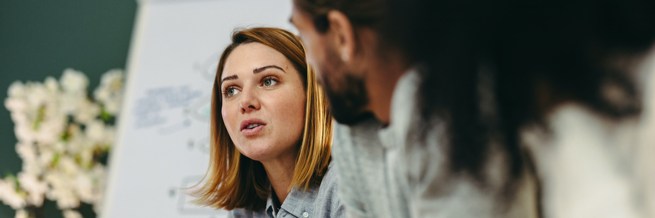 Nonprofit Doesn’t Mean No Profit, but My Paycheck Begs to Differ Woman professional in office having discussion with colleagues