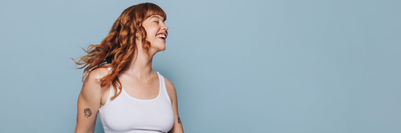 6 Tips on Asking for Help Without Hating It Woman with auburn hair smiling and dancing