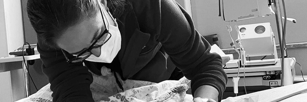 The System Is Breaking Us All: A Physician's Call to Action Contributor in her role as physician, carefully leaning over a patient